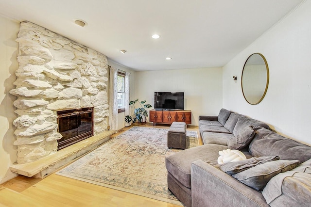 living room with hardwood / wood-style flooring and a fireplace