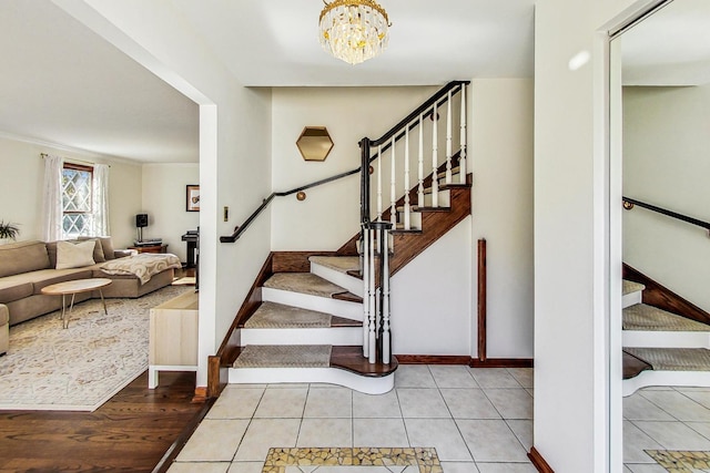 staircase featuring an inviting chandelier and tile patterned flooring