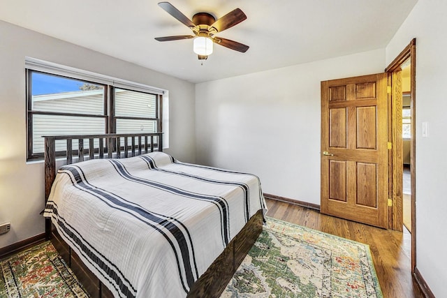 bedroom with hardwood / wood-style flooring and ceiling fan