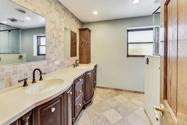 bathroom featuring vanity and decorative backsplash