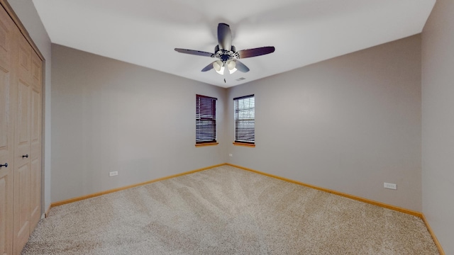 empty room with carpet floors and ceiling fan