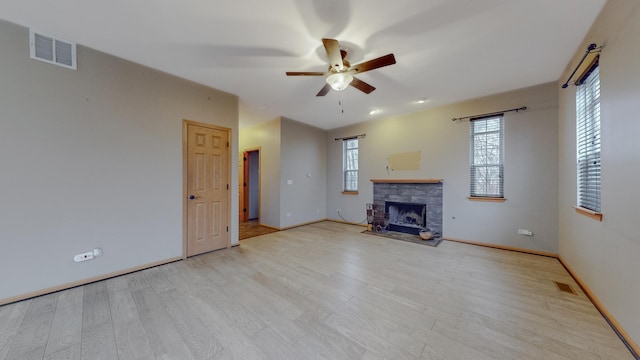 unfurnished living room featuring ceiling fan and light hardwood / wood-style floors