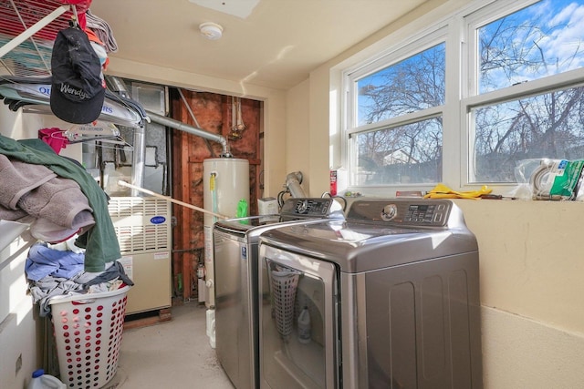 washroom with water heater and separate washer and dryer