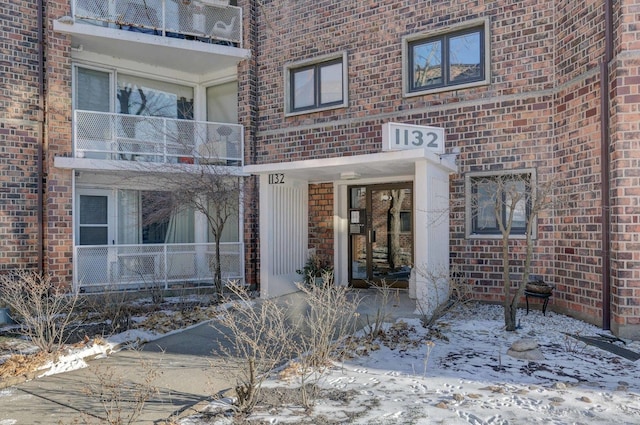 view of snow covered property entrance