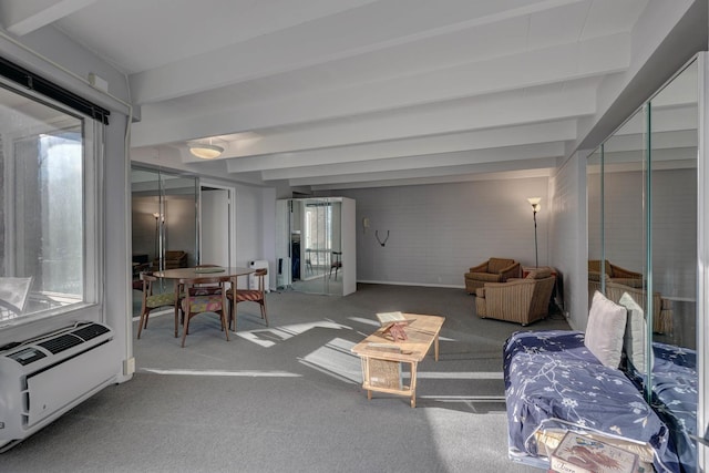 sunroom with plenty of natural light, beam ceiling, and heating unit