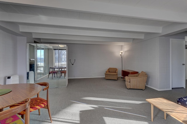 living room with beam ceiling and carpet flooring