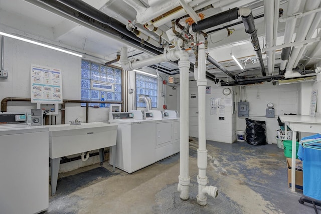 basement with sink and washer and dryer