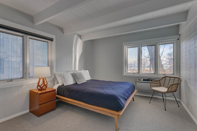 carpeted bedroom with beam ceiling and a wall unit AC