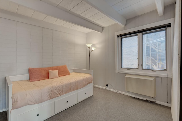 carpeted bedroom featuring radiator and beam ceiling