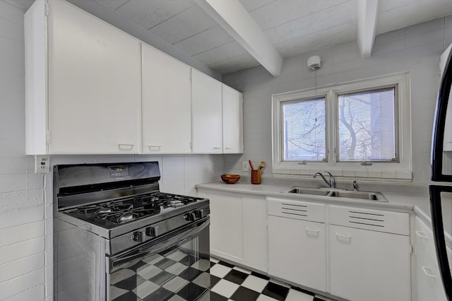 kitchen with white cabinetry, sink, black appliances, and beamed ceiling