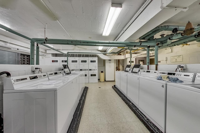 clothes washing area with washing machine and clothes dryer