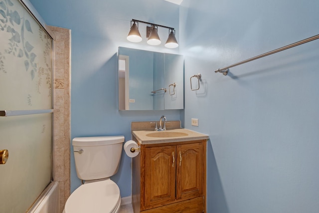 bathroom with vanity, toilet, and enclosed tub / shower combo