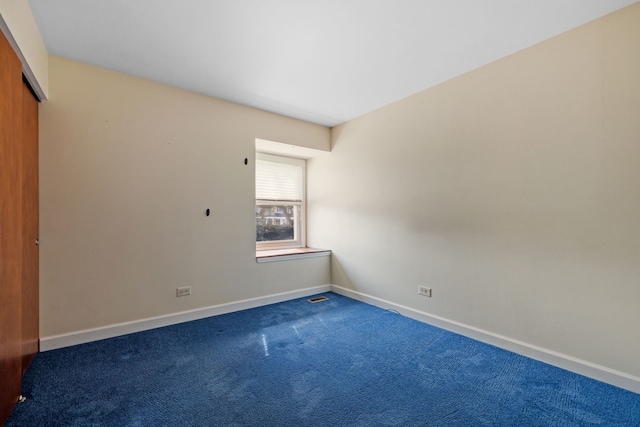 carpeted spare room with baseboards