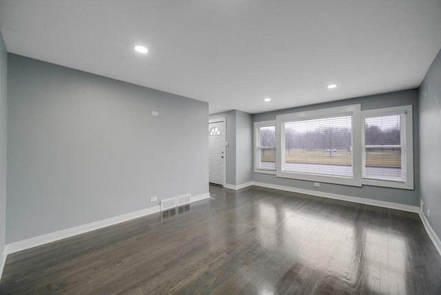 spare room with dark hardwood / wood-style floors