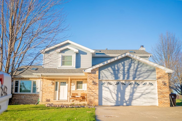 view of front of home with a garage and a front lawn