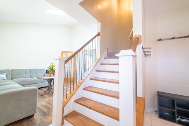 stairs featuring hardwood / wood-style floors