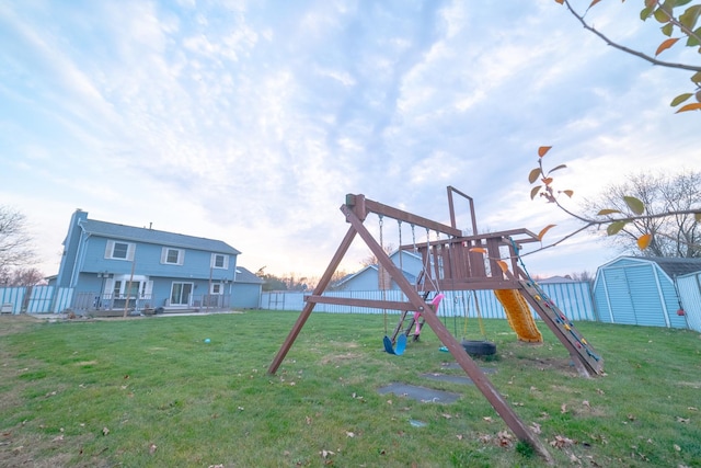 view of play area featuring a storage shed and a lawn