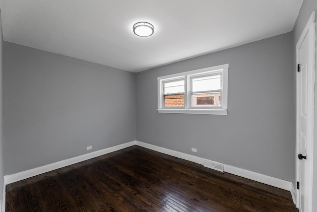 unfurnished room featuring dark wood-type flooring