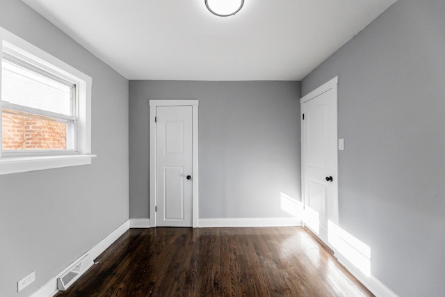 spare room featuring dark hardwood / wood-style flooring