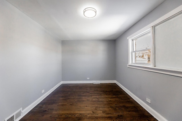 empty room with dark hardwood / wood-style floors