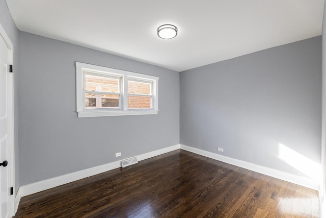 empty room with dark wood-type flooring