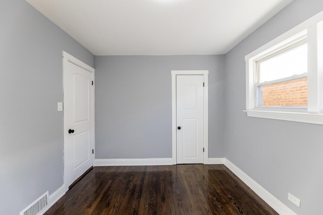 spare room featuring dark wood-type flooring