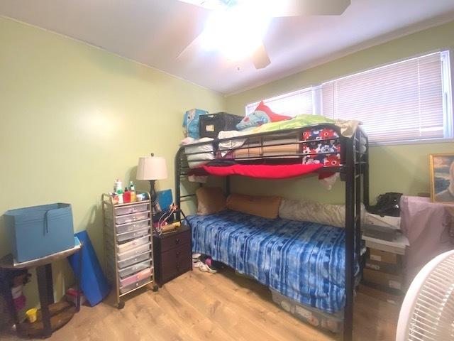 bedroom with hardwood / wood-style flooring and ceiling fan