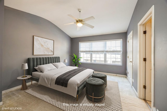 bedroom featuring lofted ceiling, baseboards, a ceiling fan, and light colored carpet