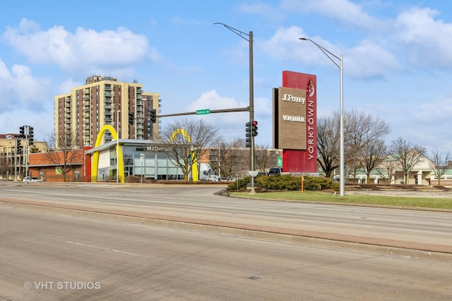 view of street with street lights and curbs