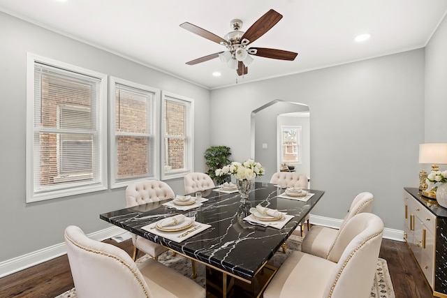 dining space with ornamental molding, dark wood-type flooring, and ceiling fan