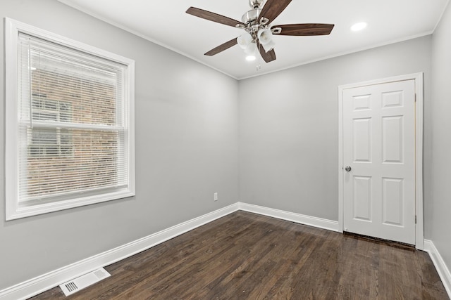 empty room with ceiling fan, ornamental molding, and dark hardwood / wood-style floors