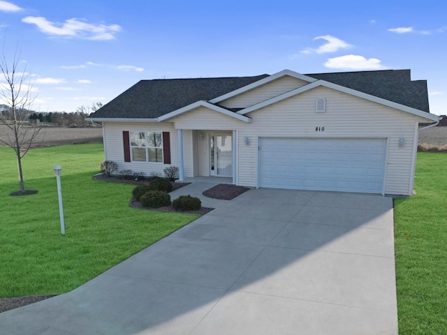 ranch-style house featuring a garage and a front yard