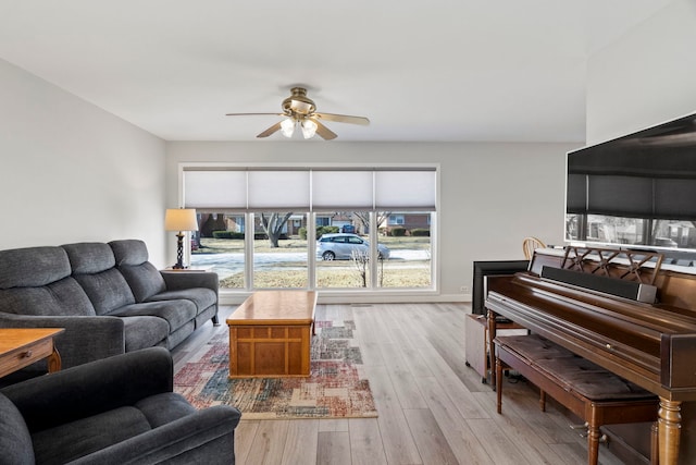 living room featuring ceiling fan and light hardwood / wood-style floors