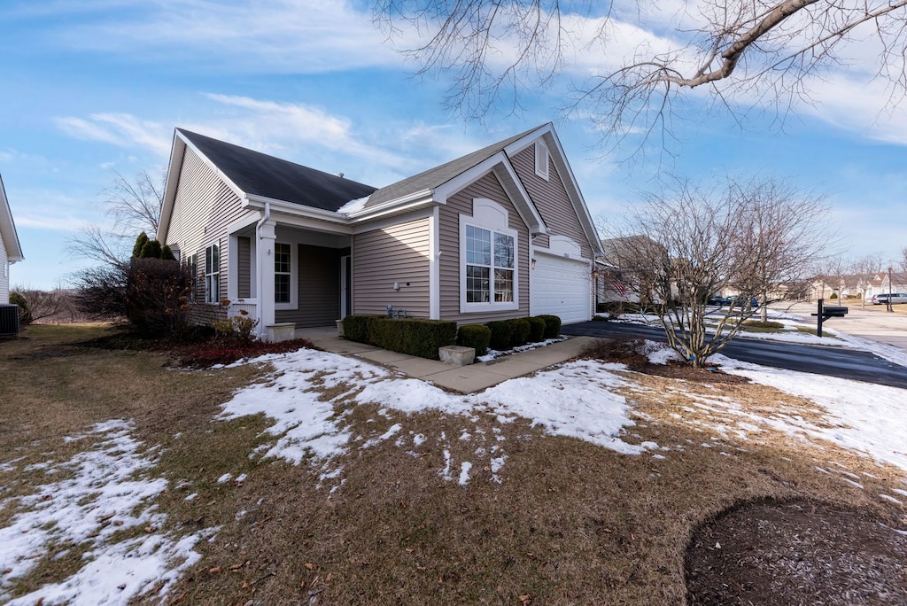 view of snow covered exterior featuring a garage