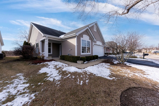 view of snow covered exterior featuring a garage