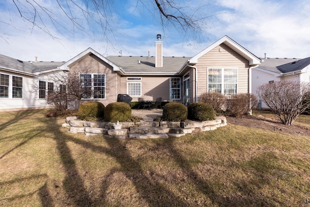 back of house featuring a yard