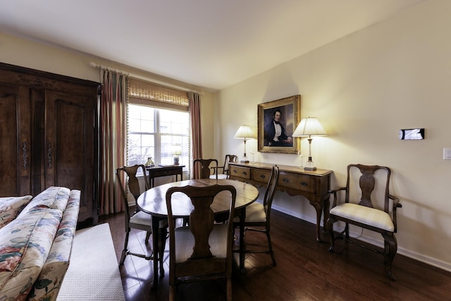 dining area featuring dark wood-type flooring