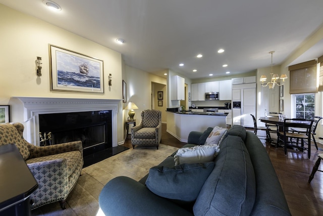 living room with dark wood-type flooring and a notable chandelier