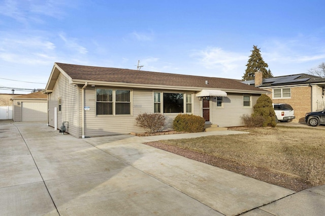 ranch-style house featuring an outbuilding and a garage