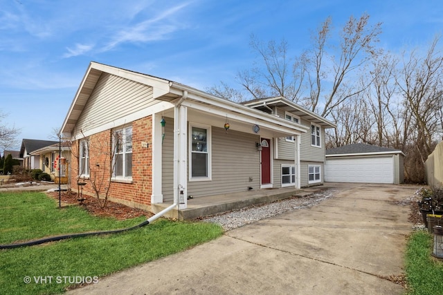 view of front of house with an outbuilding, a porch, a garage, and a front lawn