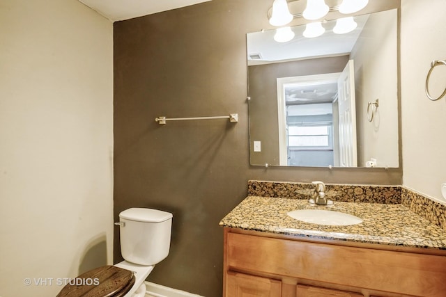 bathroom featuring vanity and toilet