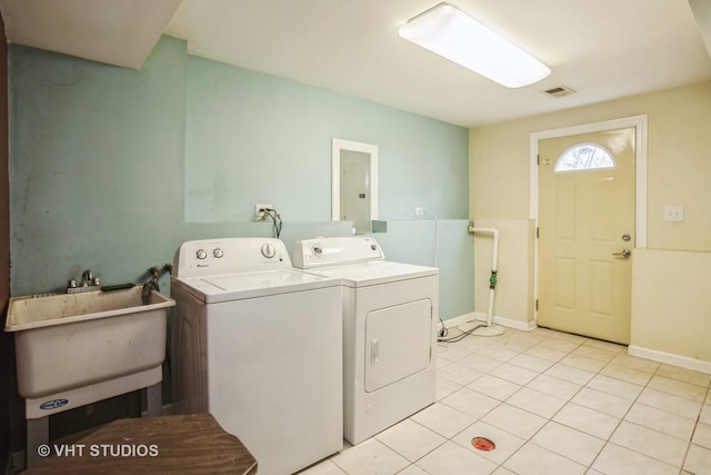 laundry room featuring separate washer and dryer, sink, light tile patterned floors, and electric panel