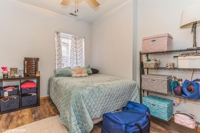 bedroom with dark wood-type flooring and ceiling fan