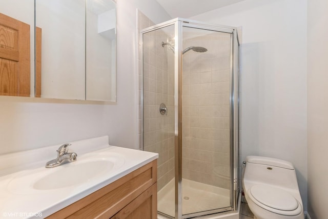 bathroom with vanity, toilet, and walk in shower