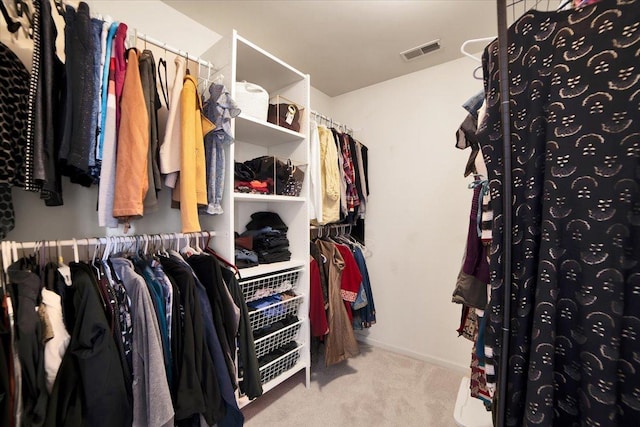 spacious closet featuring light carpet