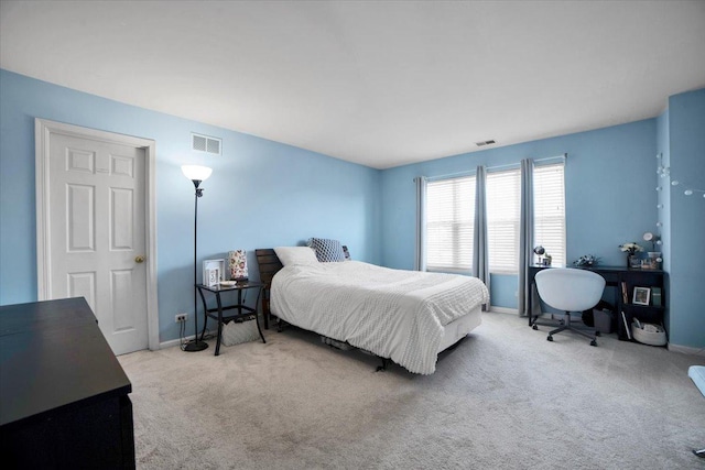 bedroom featuring light carpet