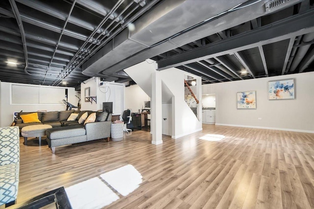 basement with light hardwood / wood-style floors