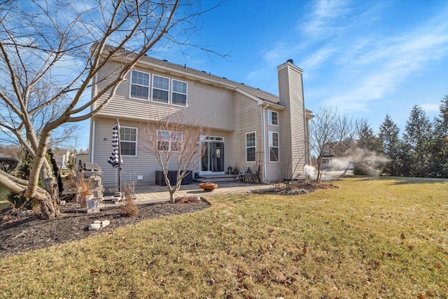 back of house with a yard and a patio area