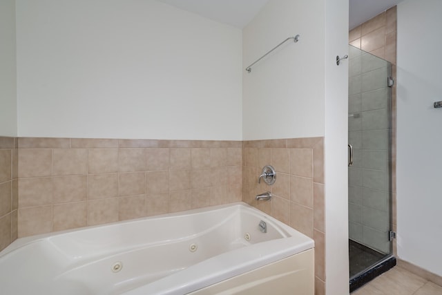 bathroom with tile patterned floors and plus walk in shower