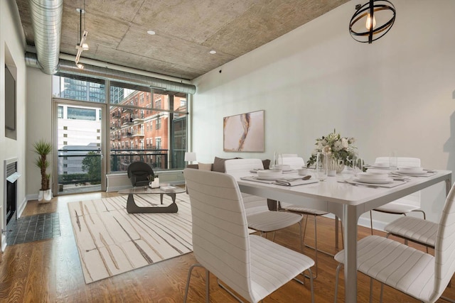 dining area featuring floor to ceiling windows and dark hardwood / wood-style flooring